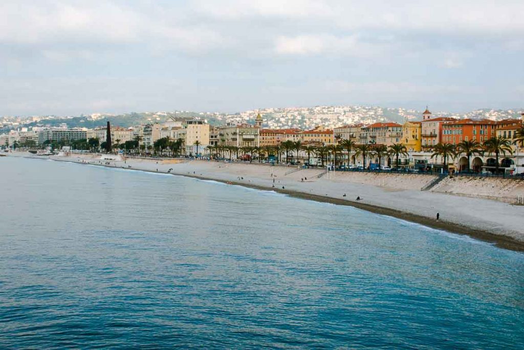 Nice's Coast with lines of colorful buildings under cloudy skies in the South of France in October