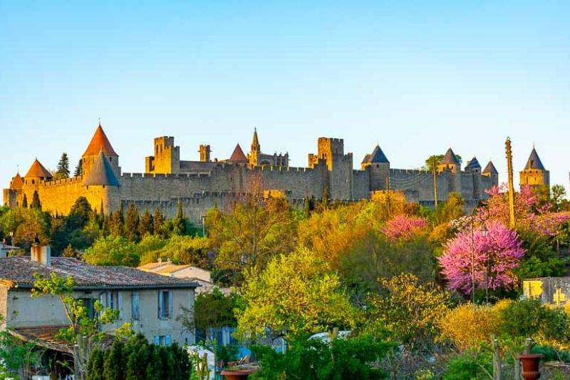 The medieval citadel of Carcassonne with the view of the town surrounded by trees in South of France in October