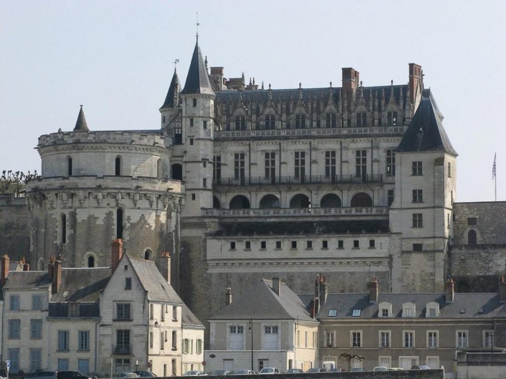 Amboise Castle, one of the Loire Valley Castles, featuring its medieval castle details behind the line of gray houses