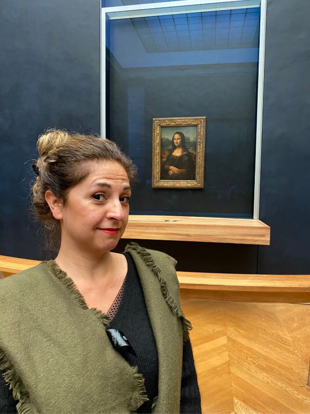 Me in a selfie with the Mona Lisa in the back in September in Paris