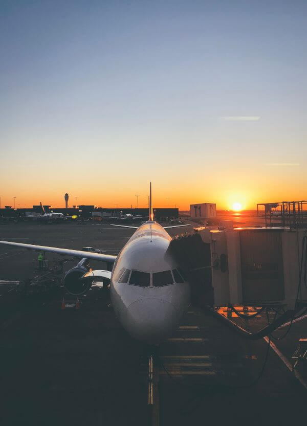 Airplane at the airport at sunset