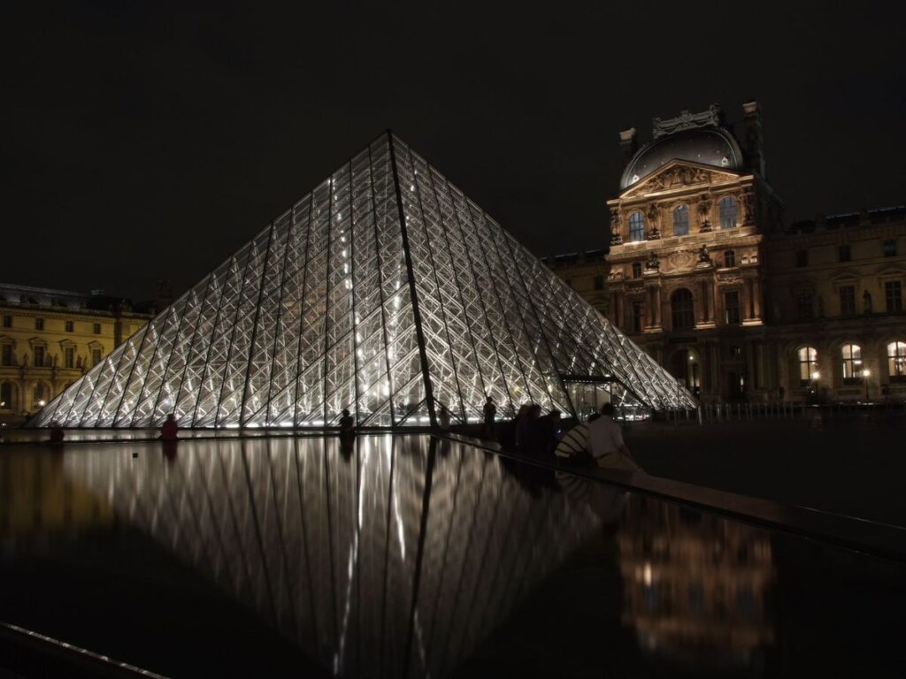 Louvre Museum glowing at night in paris in winter