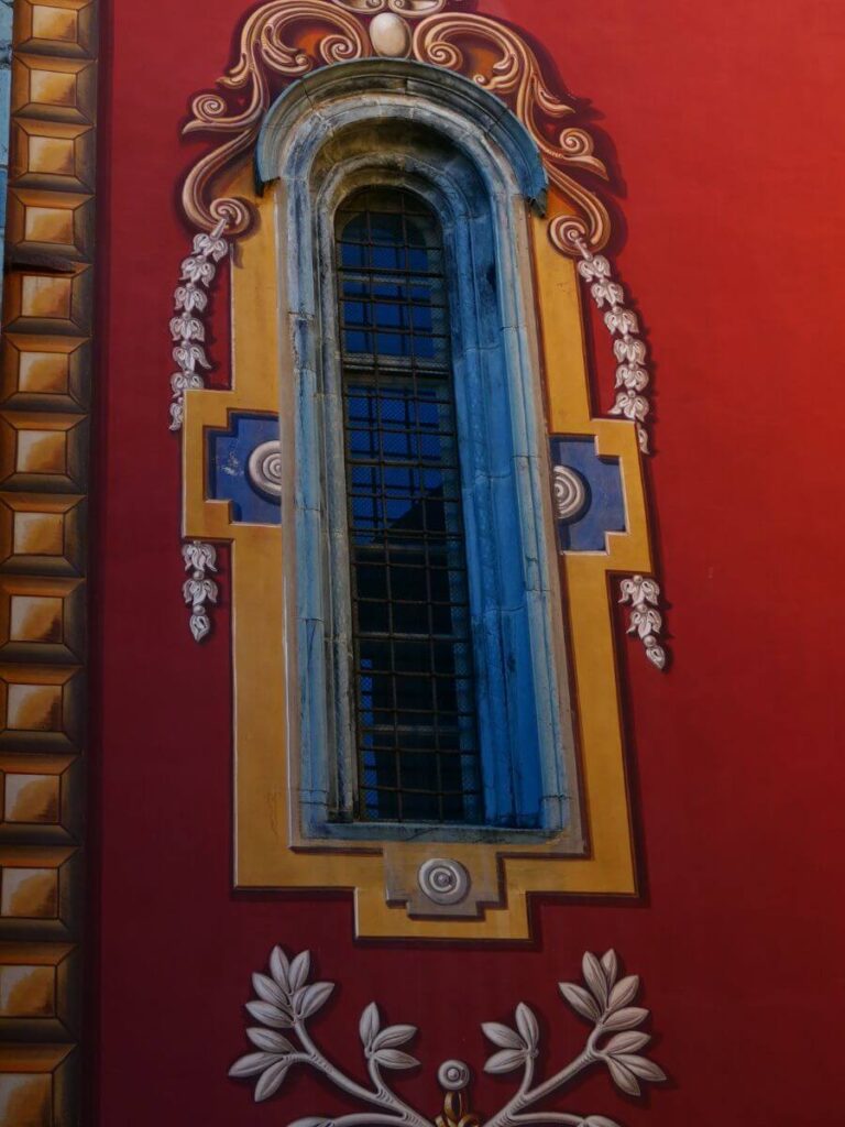 Window of the collegiate church of notre dame de l'assomption window painted with yellow, blue, and red