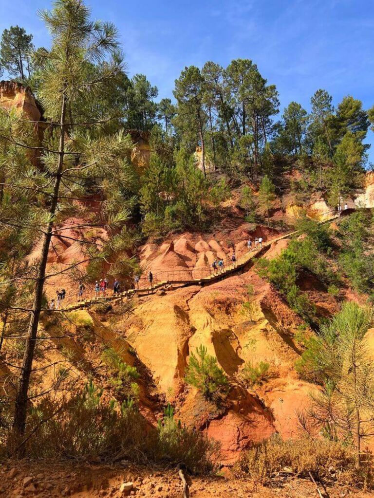 Sentier des Ochres de Roussillon, tierra roja y árboles verdes